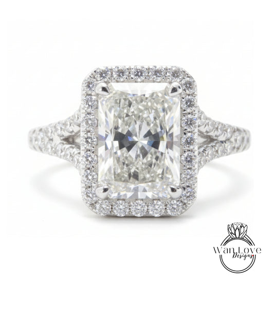 A stunning diamond engagement ring with a large central diamond surrounded by a halo of smaller diamonds set in a silver band.