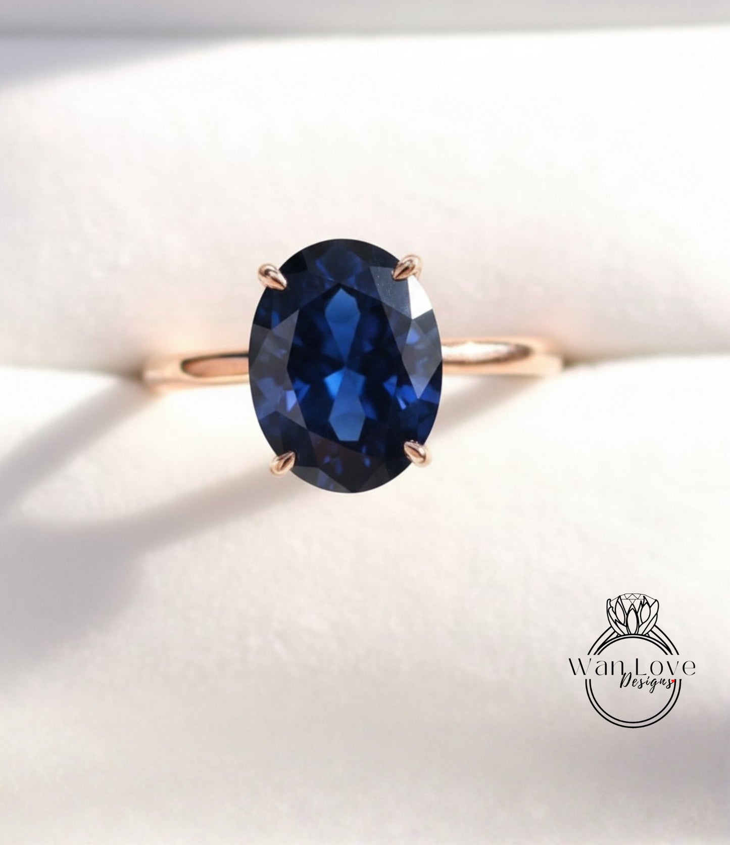 A gold ring with a large oval-shaped blue gemstone set in the center.
