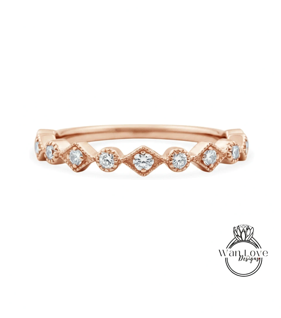 A rose gold ring with a row of small diamonds set in a diamond pattern.