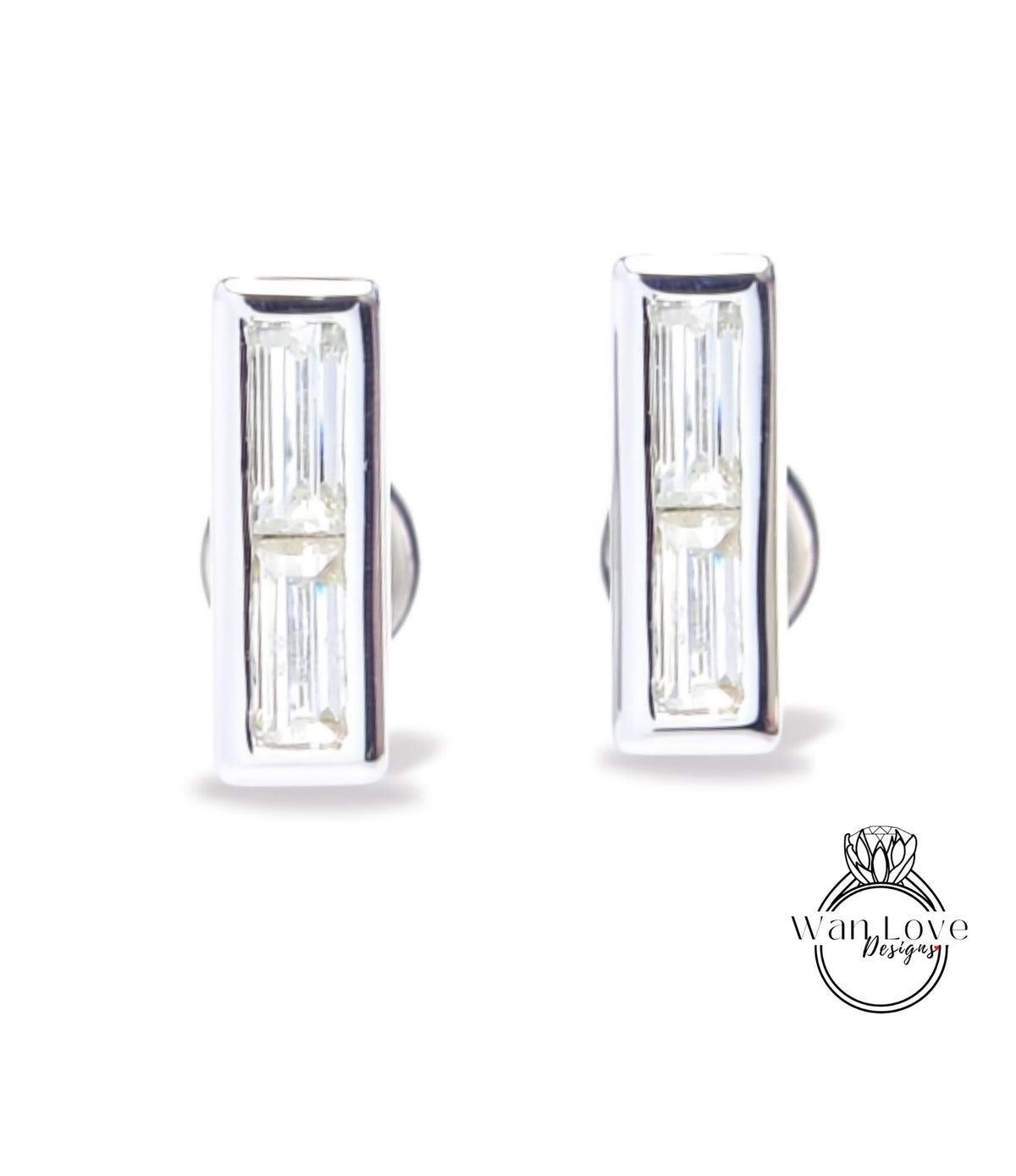 A pair of silver earrings with rectangular-shaped clear gemstones.