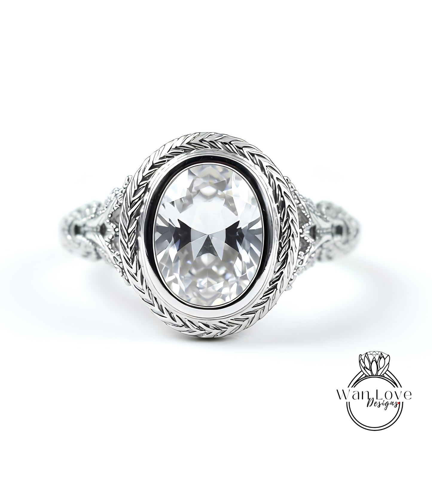 A close-up of a silver ring with a large oval-shaped gemstone, possibly a diamond, set in a decorative metal band.
