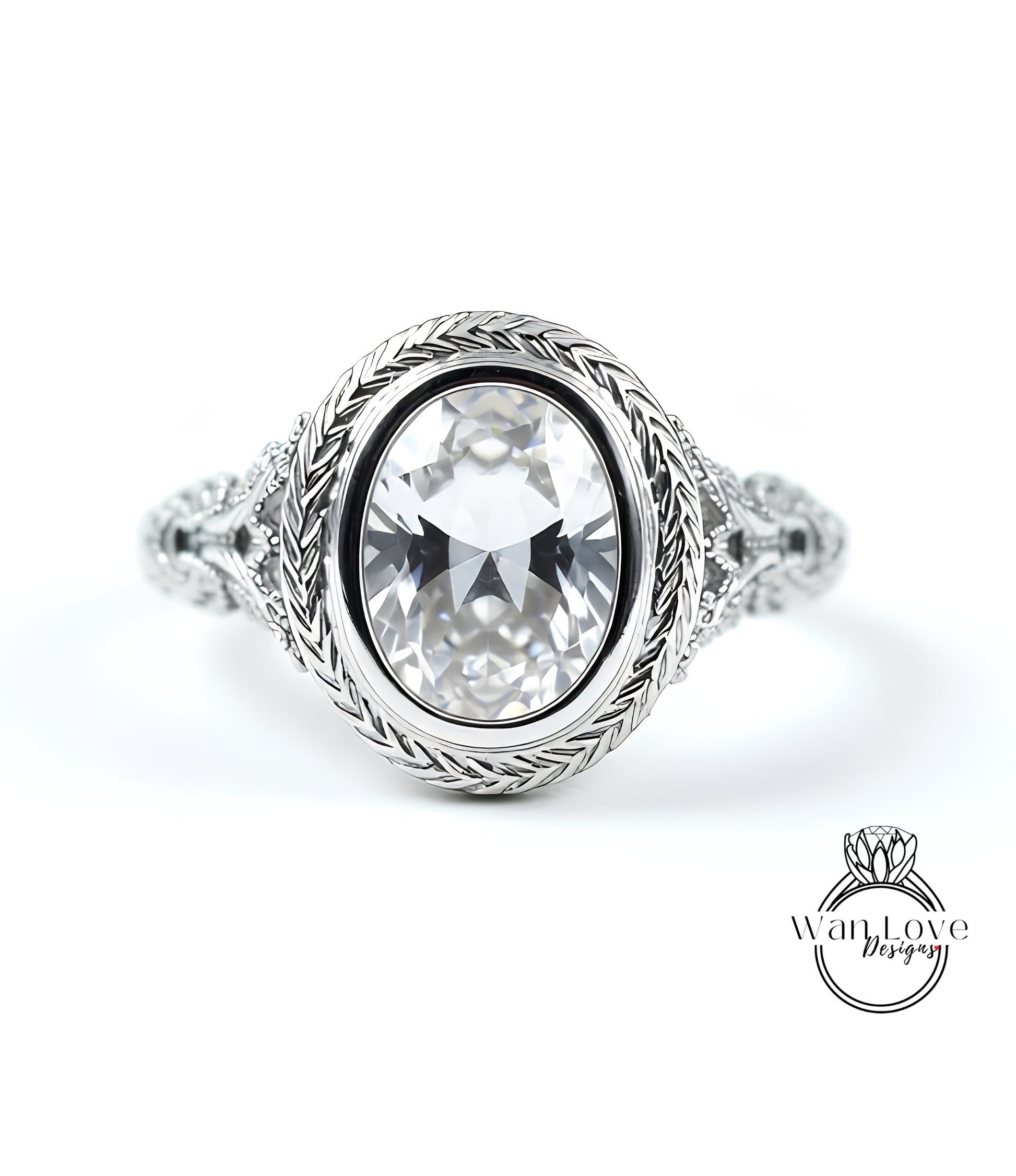 A close-up of a silver ring with a large oval-shaped gemstone, possibly a diamond, set in a decorative metal band.