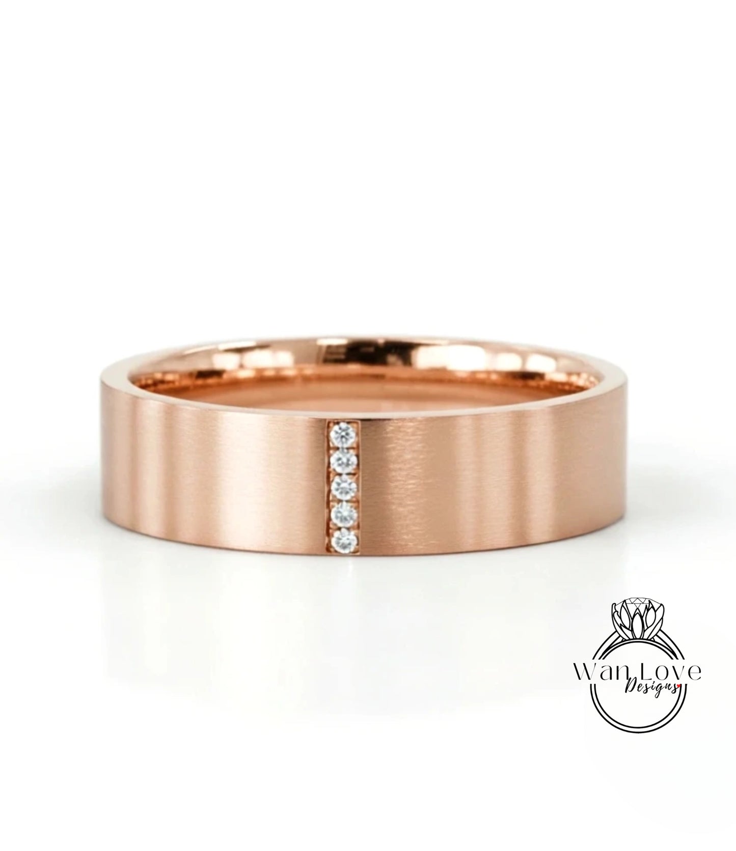 A rose gold ring with a horizontal line of diamonds set in the center.