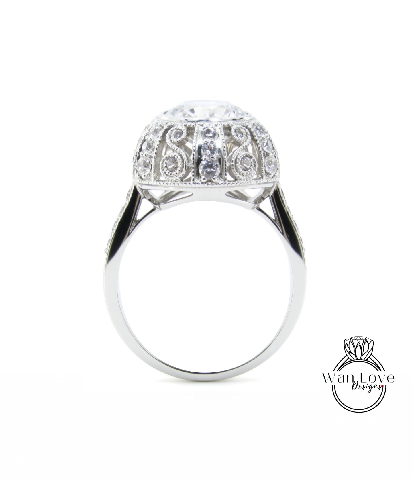 A silver ring with a large, round diamond at the center, surrounded by intricate, sparkling designs.
