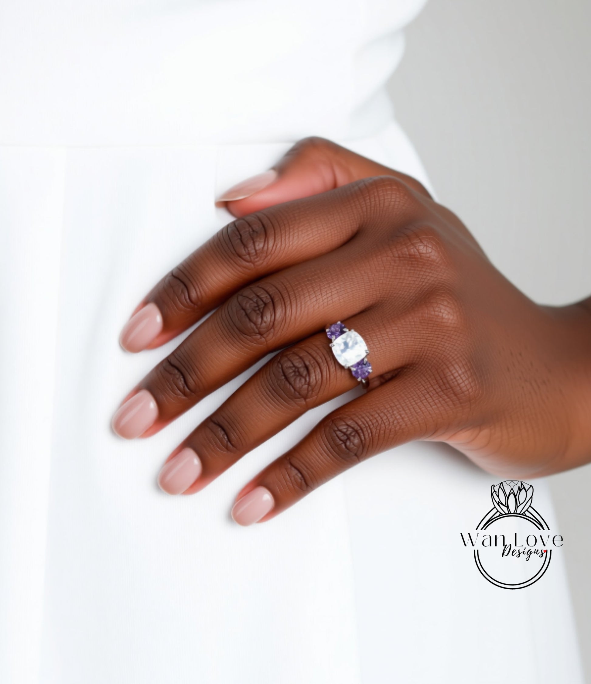 A close-up of a hand wearing a ring with a large gemstone, likely a diamond, on the ring finger.