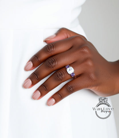 A close-up of a hand wearing a ring with a large gemstone, likely a diamond, on the ring finger.