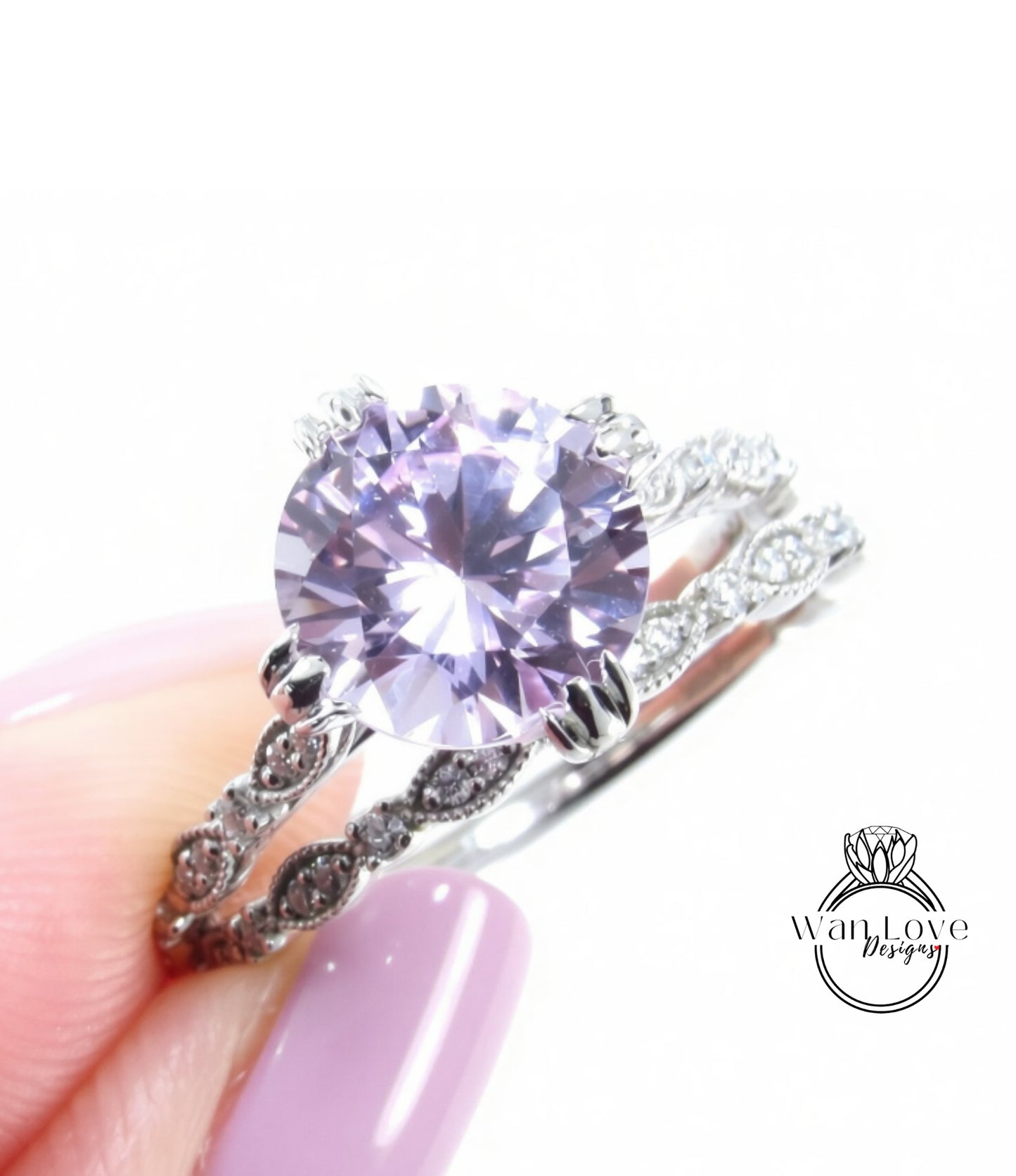 A close-up of a person's hand holding a ring with a large, round purple gemstone set in a silver band.