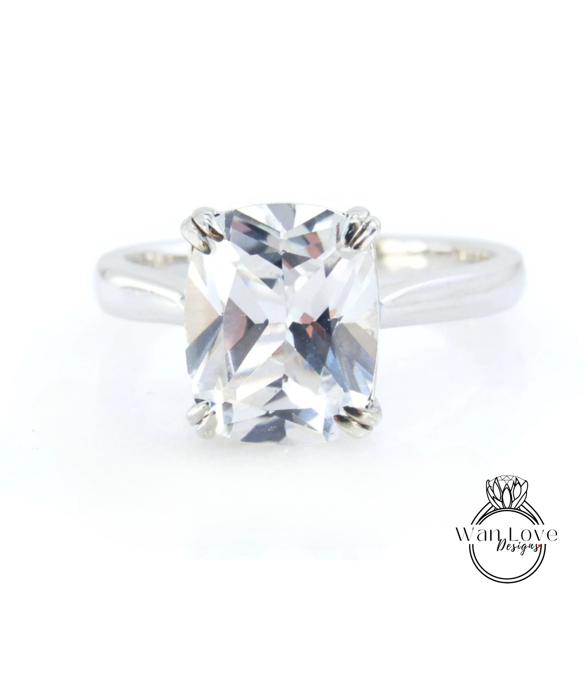 A close-up view of a diamond engagement ring with a large, clear gemstone set in a silver band.