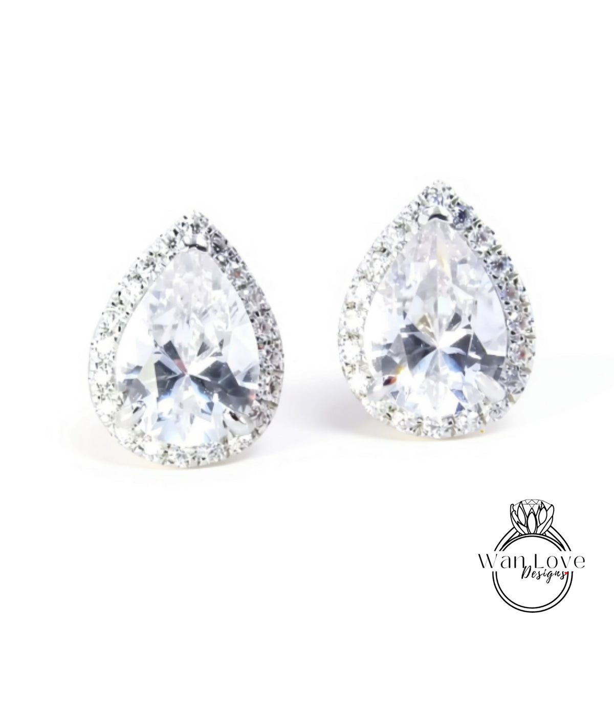 A pair of elegant earrings with large, clear gemstones set in a halo of smaller diamonds.