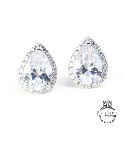 A pair of elegant earrings with large, clear gemstones set in a halo of smaller diamonds.