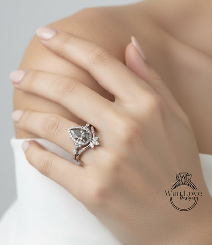 A close-up of a person's hand wearing a diamond engagement ring on the ring finger.