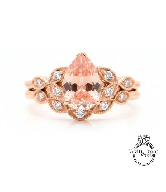 a beautiful gold ring with a large pear-shaped gemstone set in a floral design, surrounded by smaller diamonds.