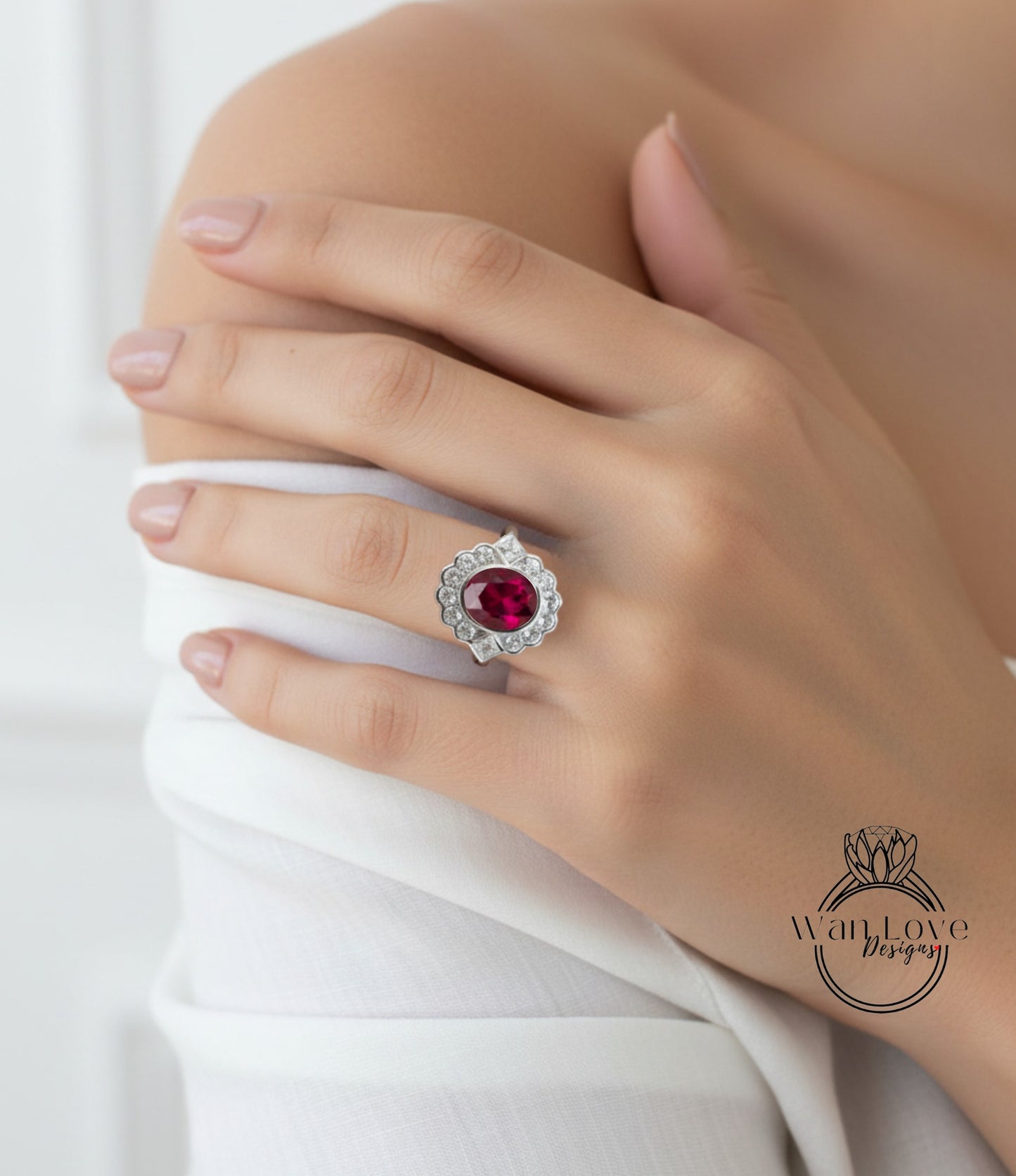 A close-up of a person's hand wearing a large, ornate ring with a red gemstone.