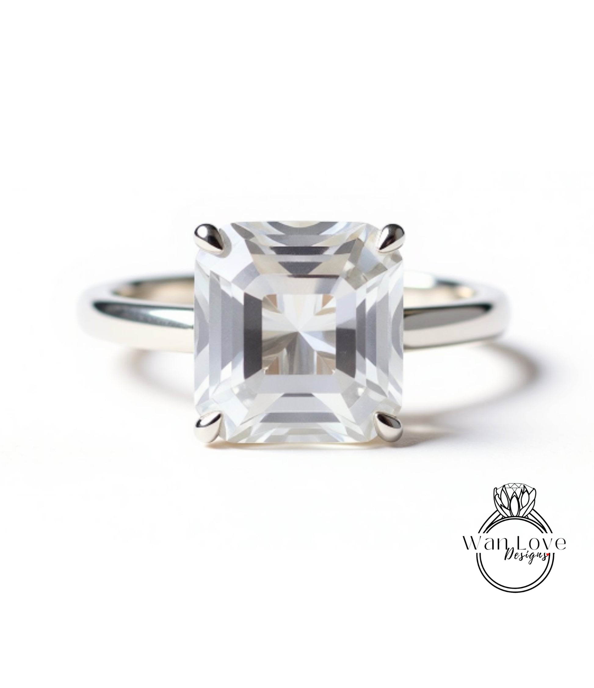 A large, clear gemstone engagement ring with a silver band.
