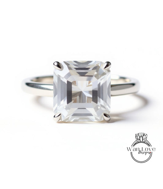 A large, clear gemstone engagement ring with a silver band.