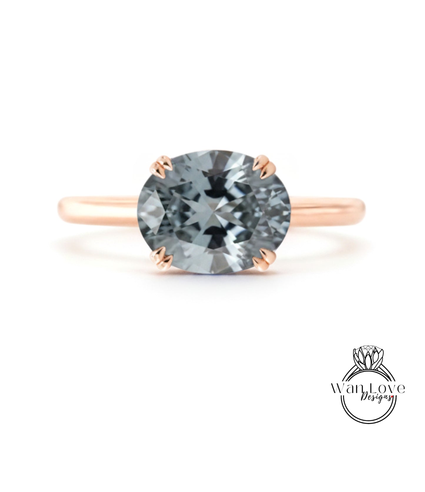 A rose gold engagement ring with a large, round, gray gemstone set in the center.
