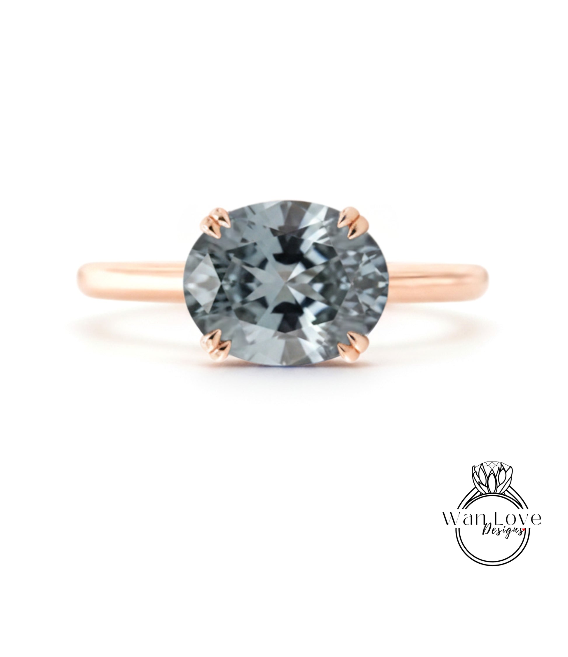 A rose gold engagement ring with a large, round, gray gemstone set in the center.