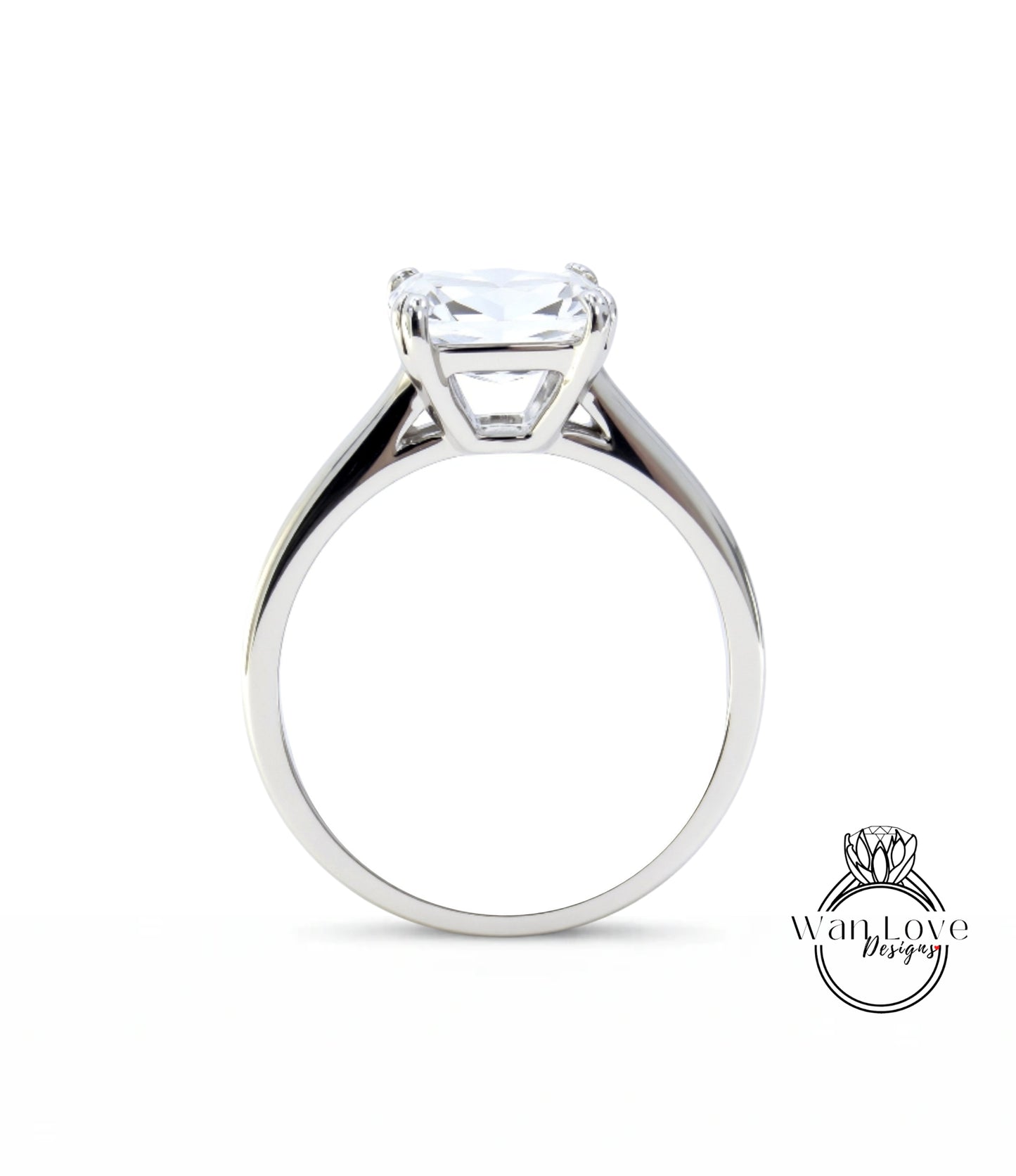 A silver engagement ring with a large, clear gemstone set in the center of the band.