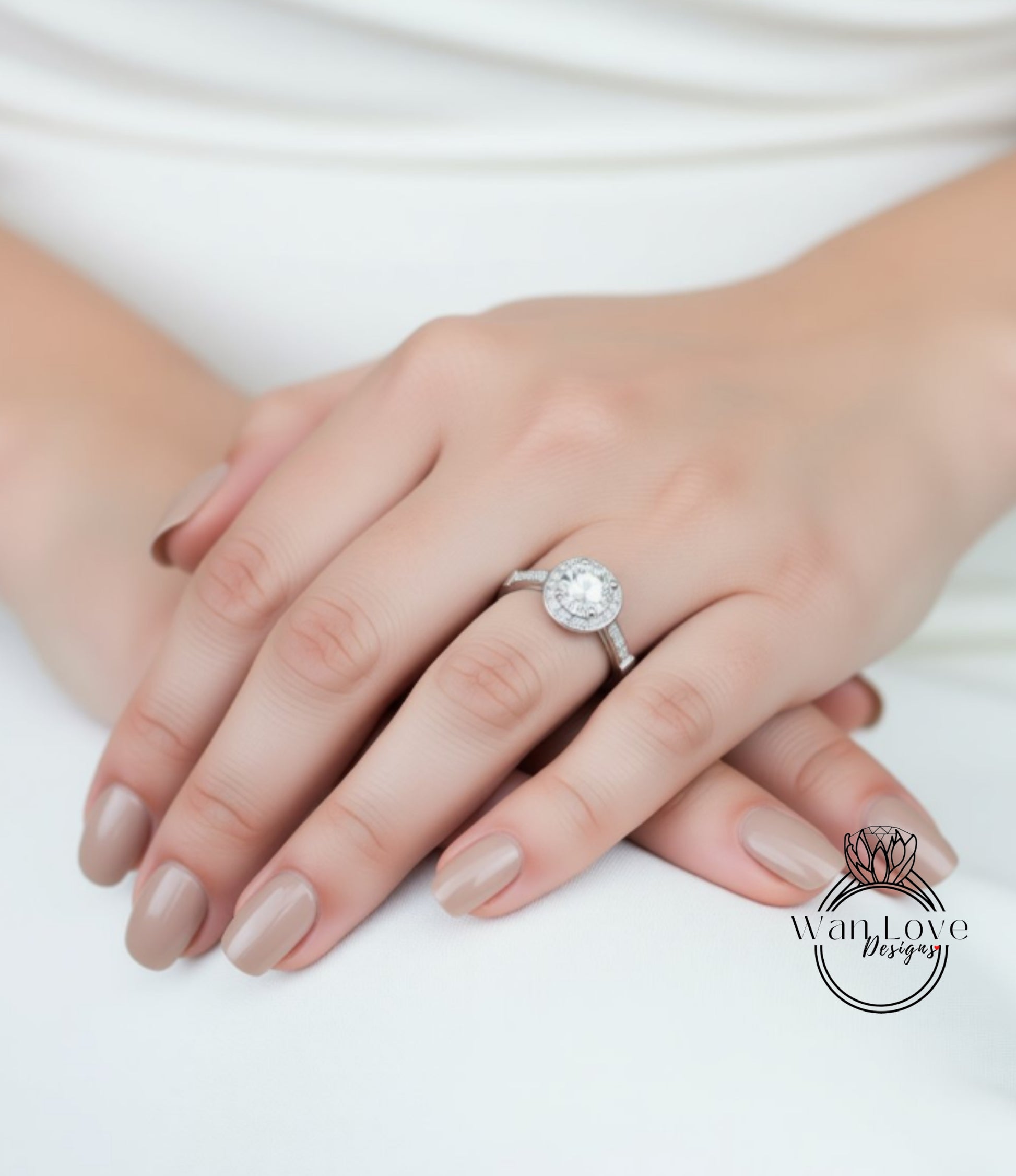 A close-up of a person's hand wearing a diamond engagement ring.