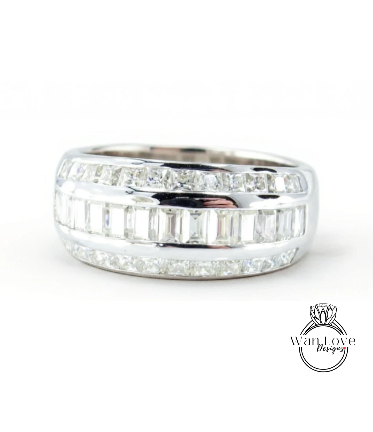 A silver ring with a row of small diamonds set in it.