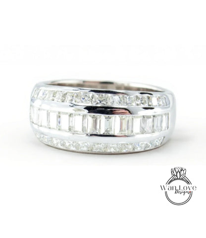 A silver ring with a row of small diamonds set in it.