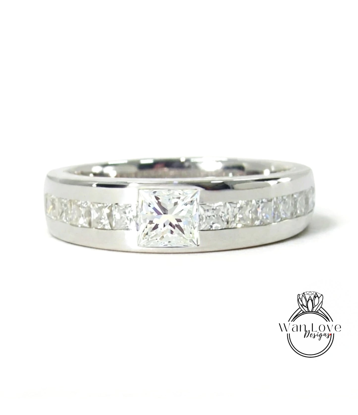 A silver ring with a large diamond set in the center, surrounded by smaller diamonds.