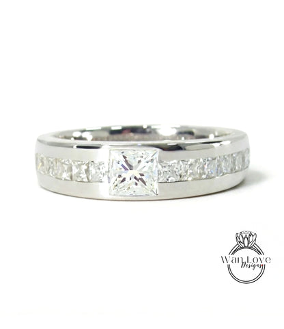 A silver ring with a large diamond set in the center, surrounded by smaller diamonds.