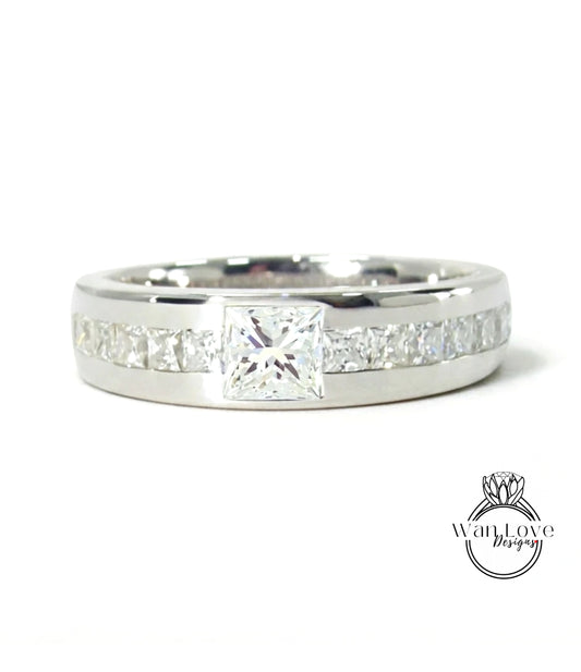 A silver ring with a large diamond set in the center, surrounded by smaller diamonds.