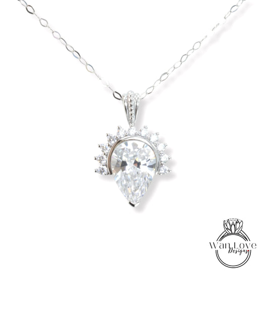 A necklace with a large, clear gemstone pendant, which appears to be a diamond.