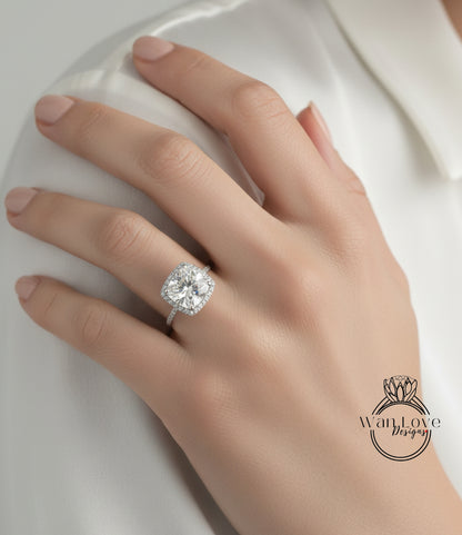 A close-up of a person's hand wearing a large, sparkling diamond engagement ring.