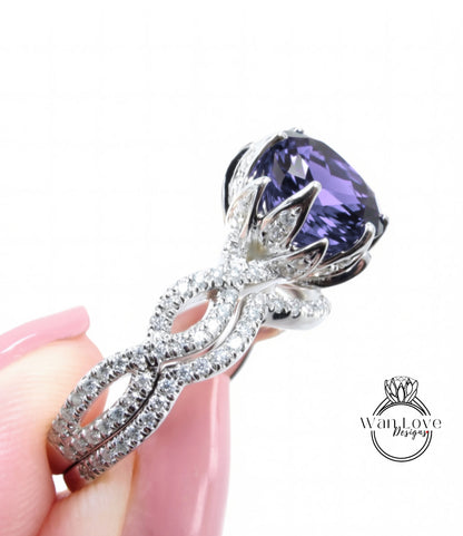 A close-up of a person's hand holding a diamond ring with a large purple gemstone.