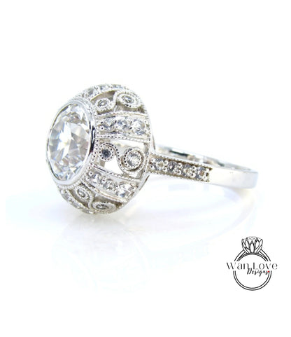 A close-up view of a diamond ring with a large central diamond surrounded by smaller diamonds and intricate metalwork.