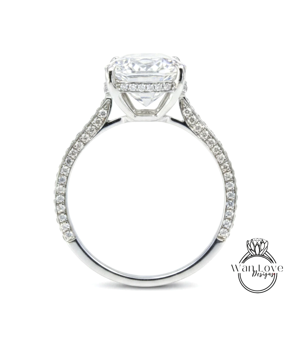A large, round diamond engagement ring with a halo of smaller diamonds around the center stone.