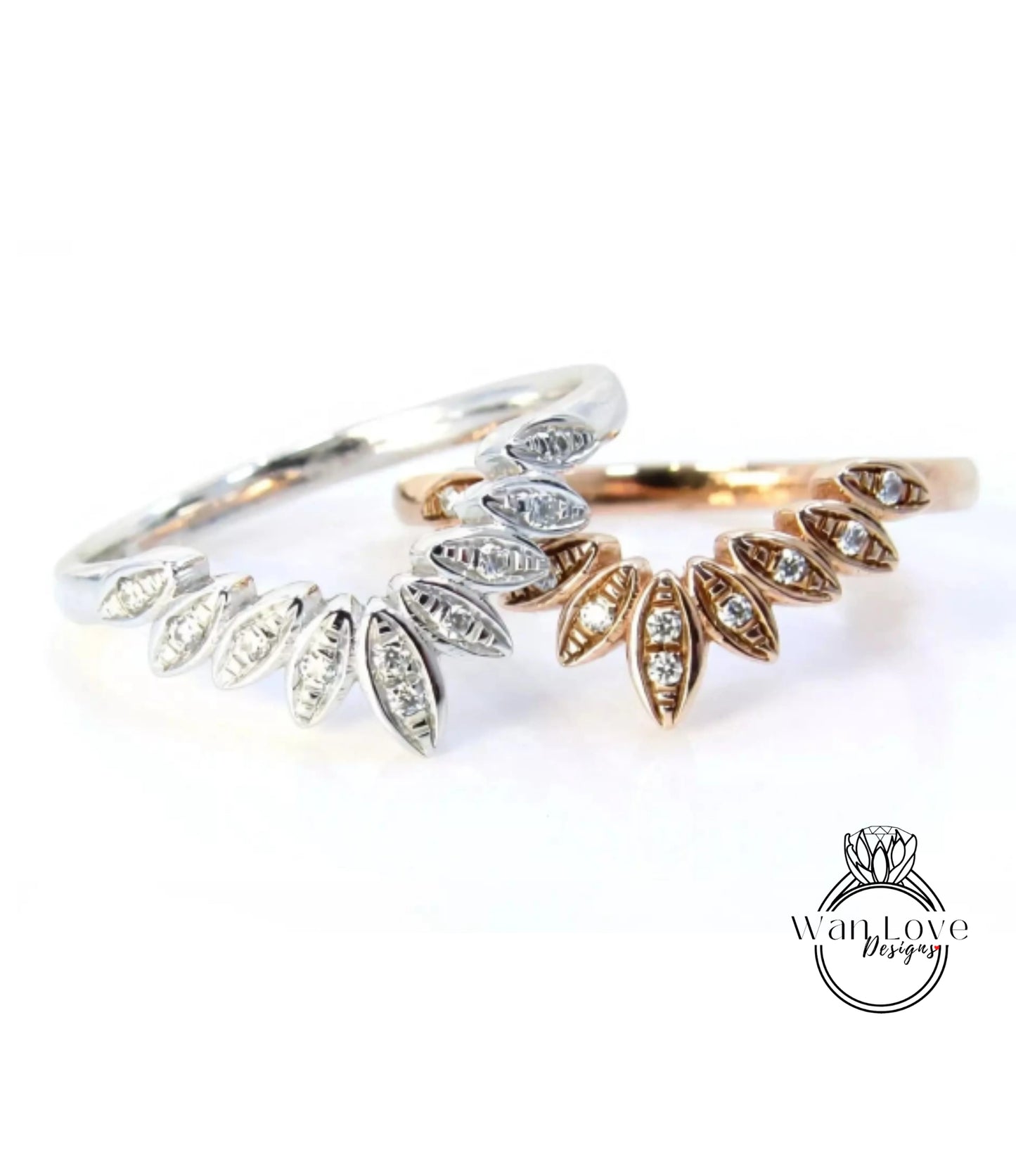 two rings with diamond-encrusted designs, one silver and one gold, placed on a white background.