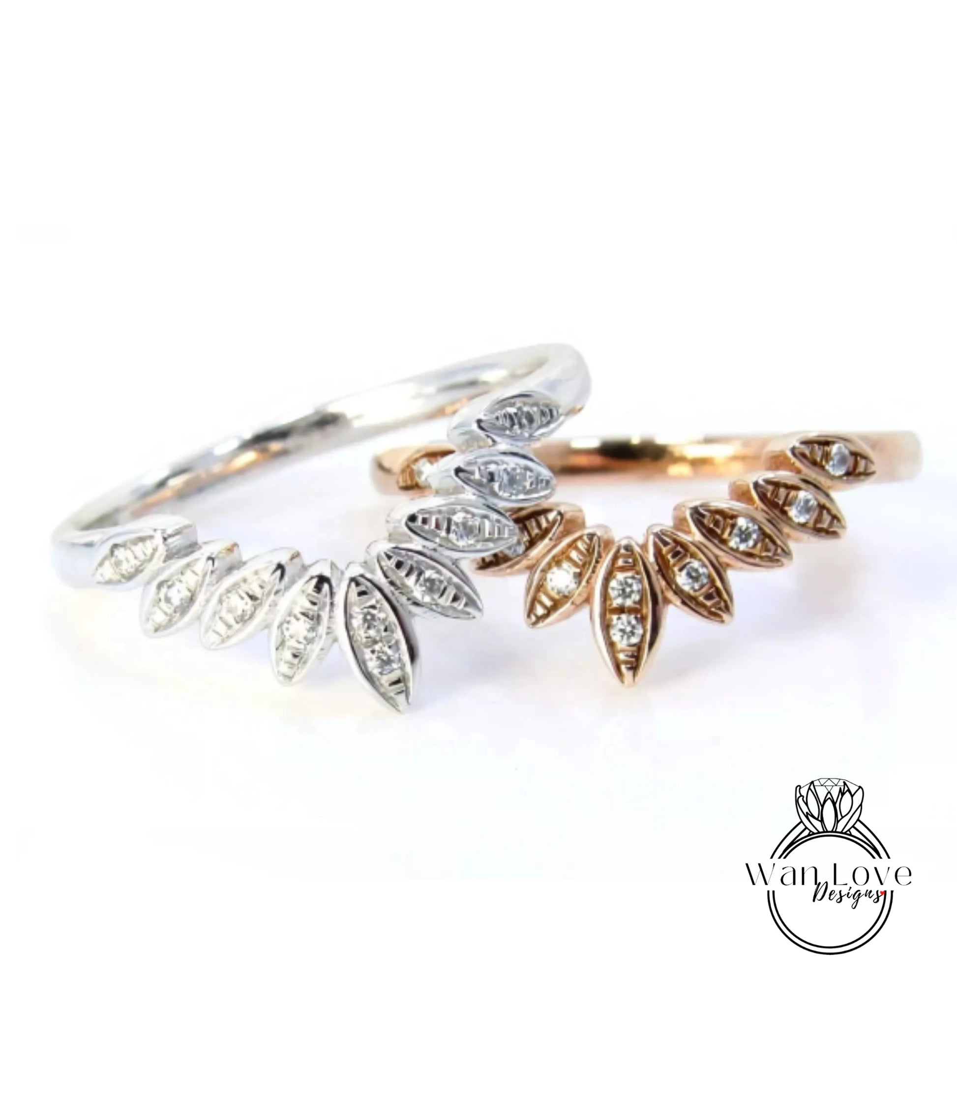 two rings with diamond-encrusted designs, one silver and one gold, placed on a white background.
