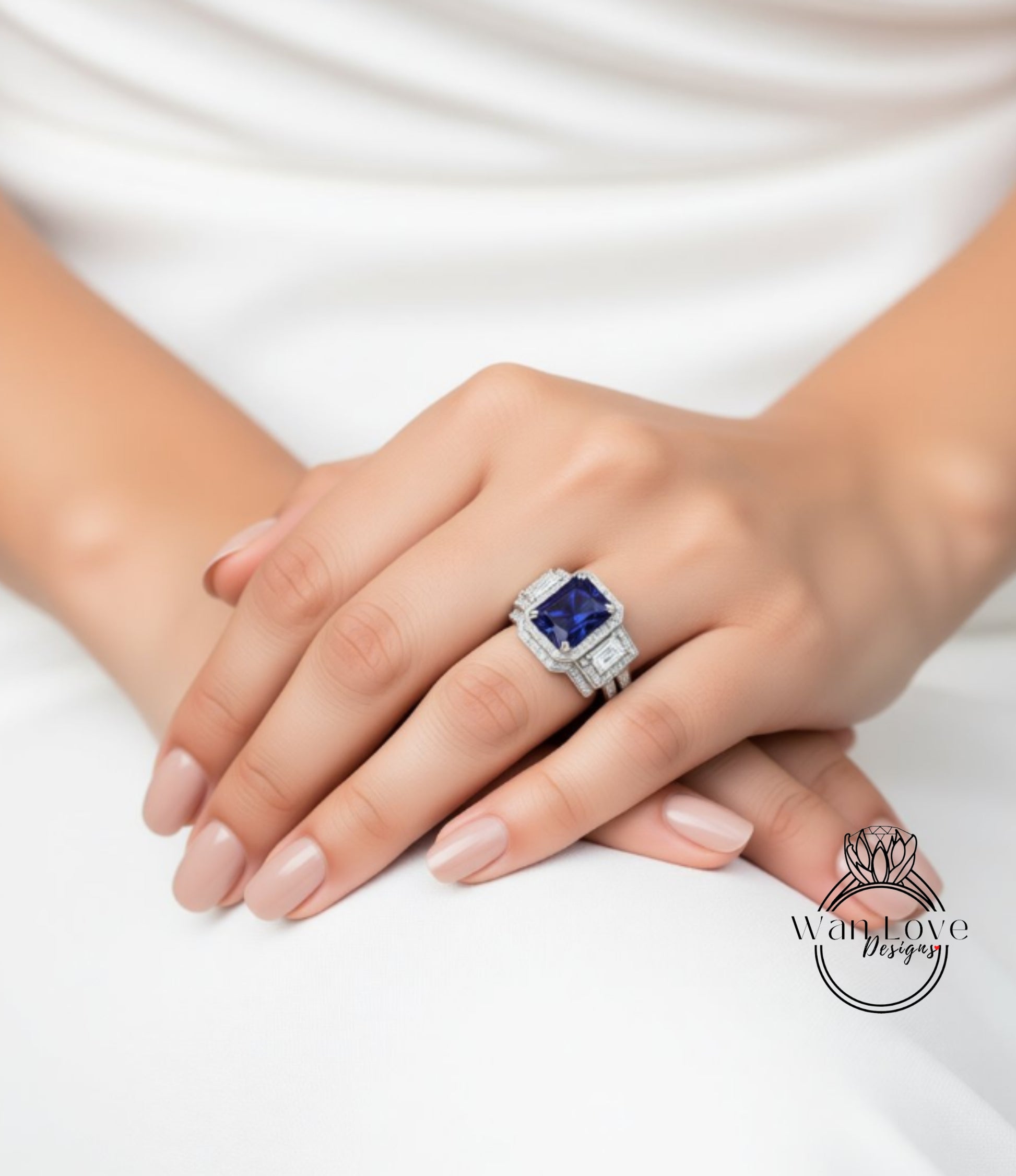 A close-up of a person's hand wearing a large, ornate ring with a blue gemstone.