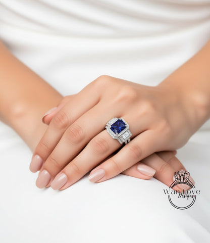 A close-up of a person's hand wearing a large, ornate ring with a blue gemstone.