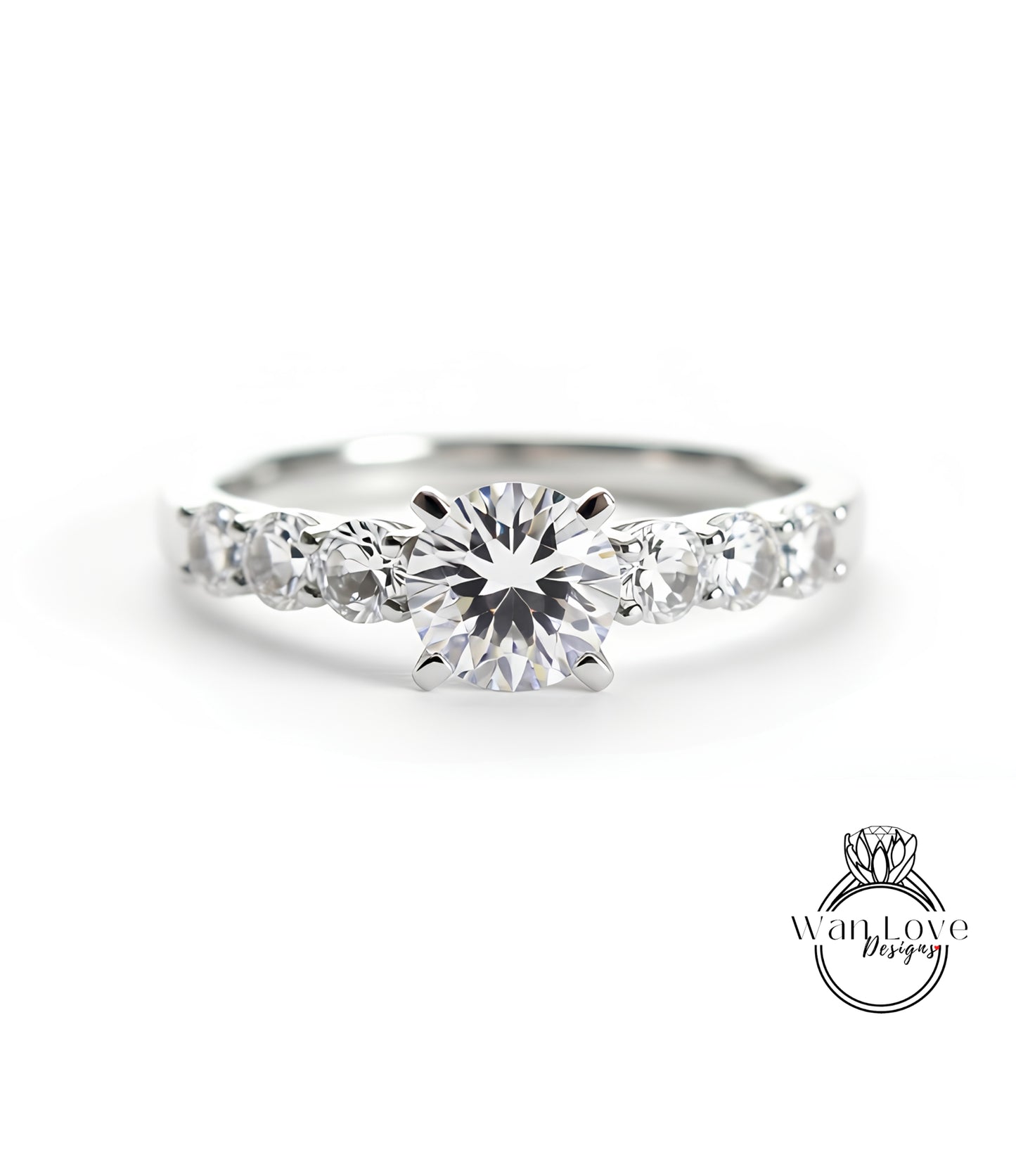 A close-up view of a diamond engagement ring with a large central diamond surrounded by smaller diamonds on either side.