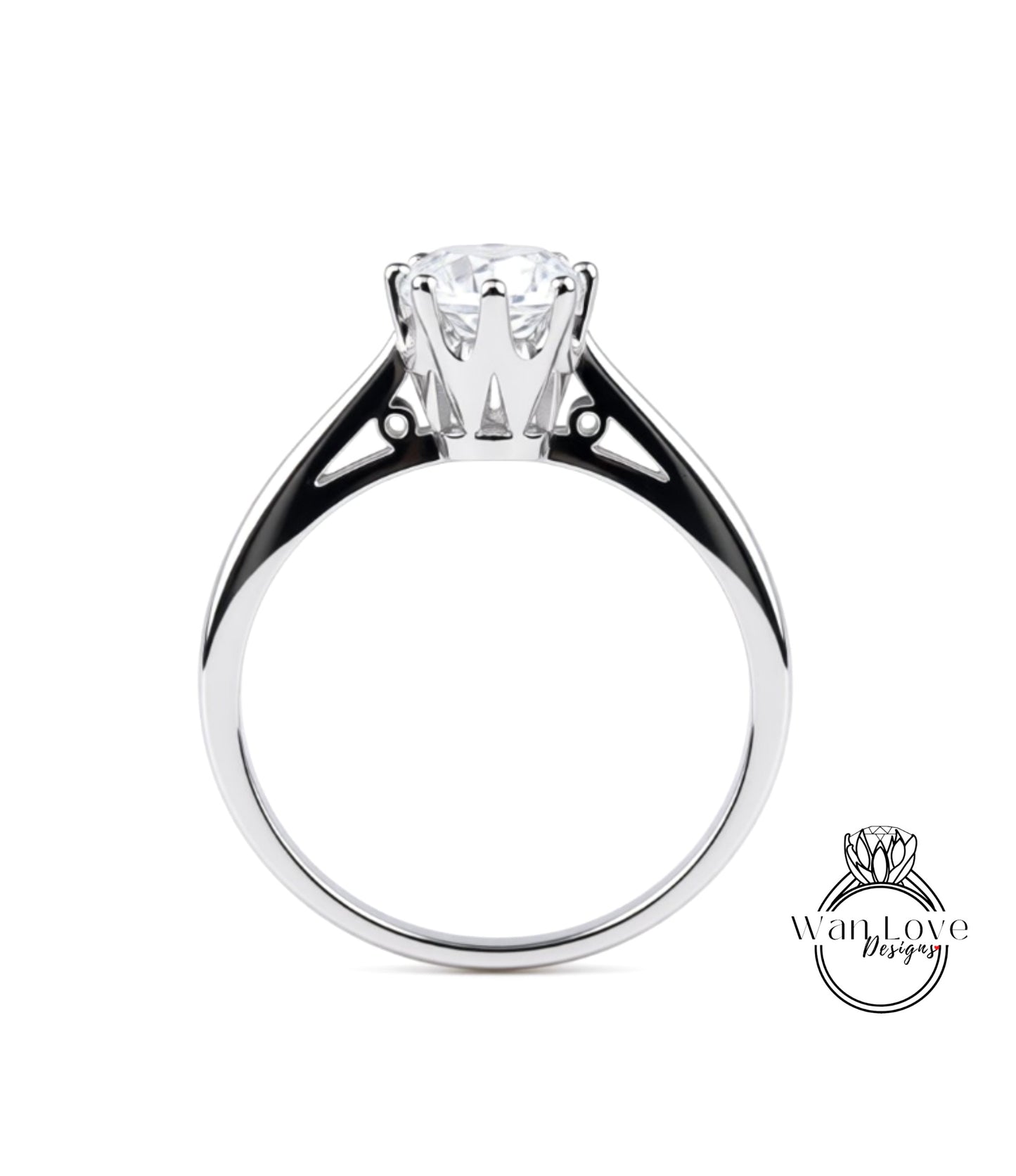 A silver engagement ring with a large central diamond and a smaller diamond on either side.