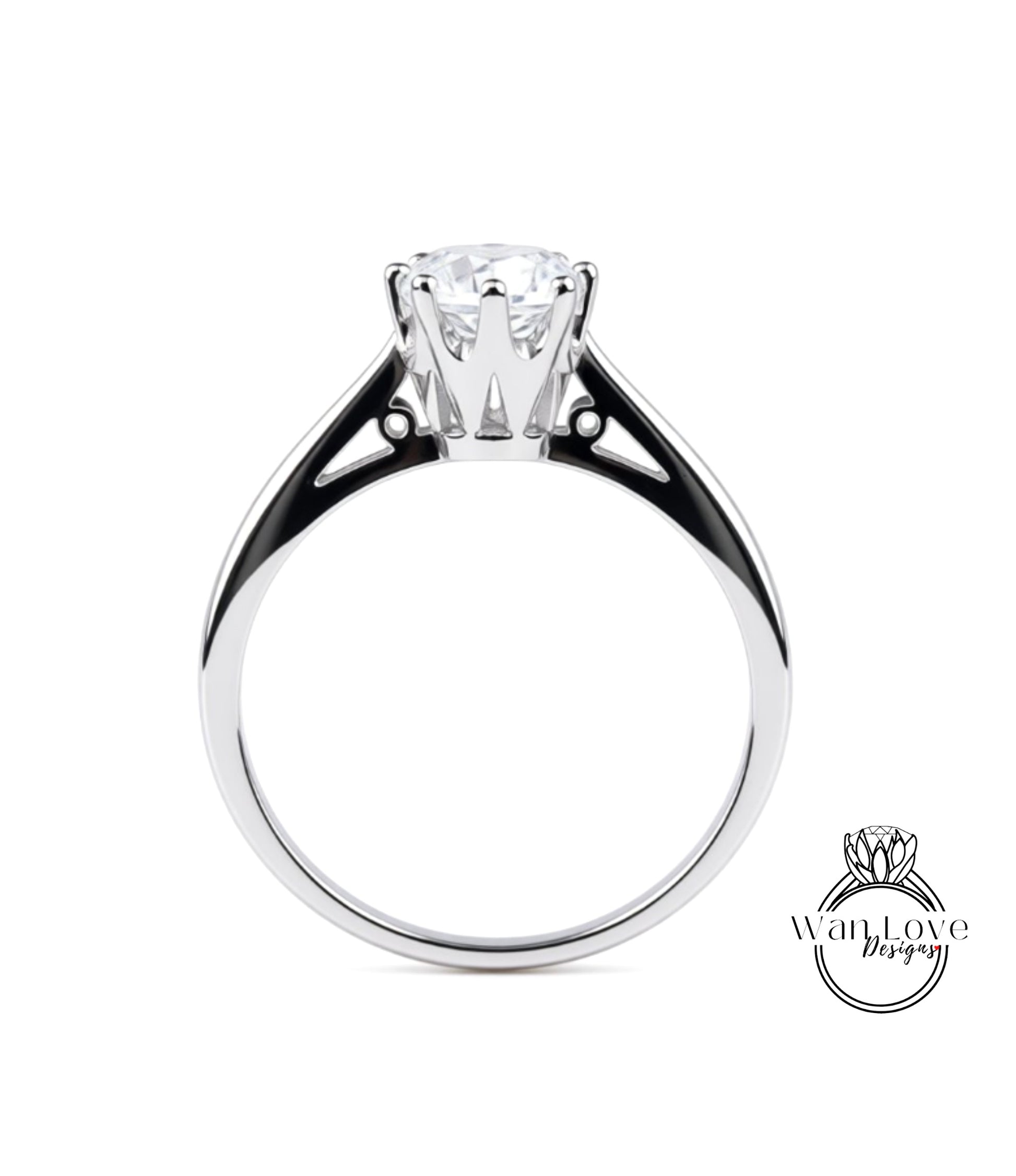 A silver engagement ring with a large central diamond and a smaller diamond on either side.