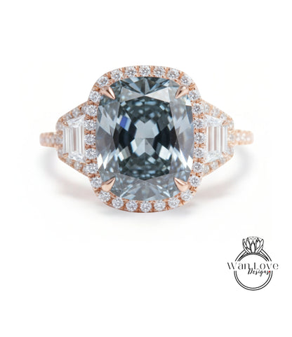 A large, blue diamond ring with a halo of smaller diamonds around the center stone.