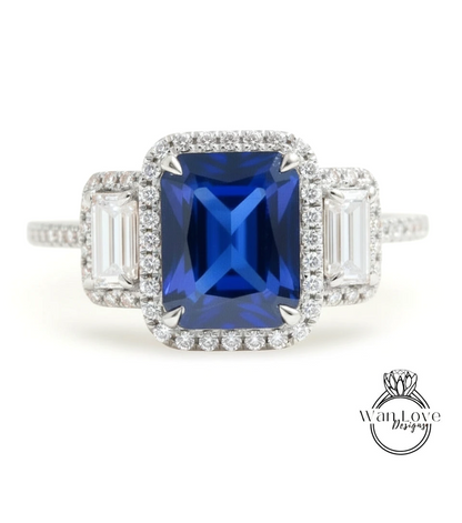 A stunning blue gemstone engagement ring with a halo of diamonds around it, set in a silver band.