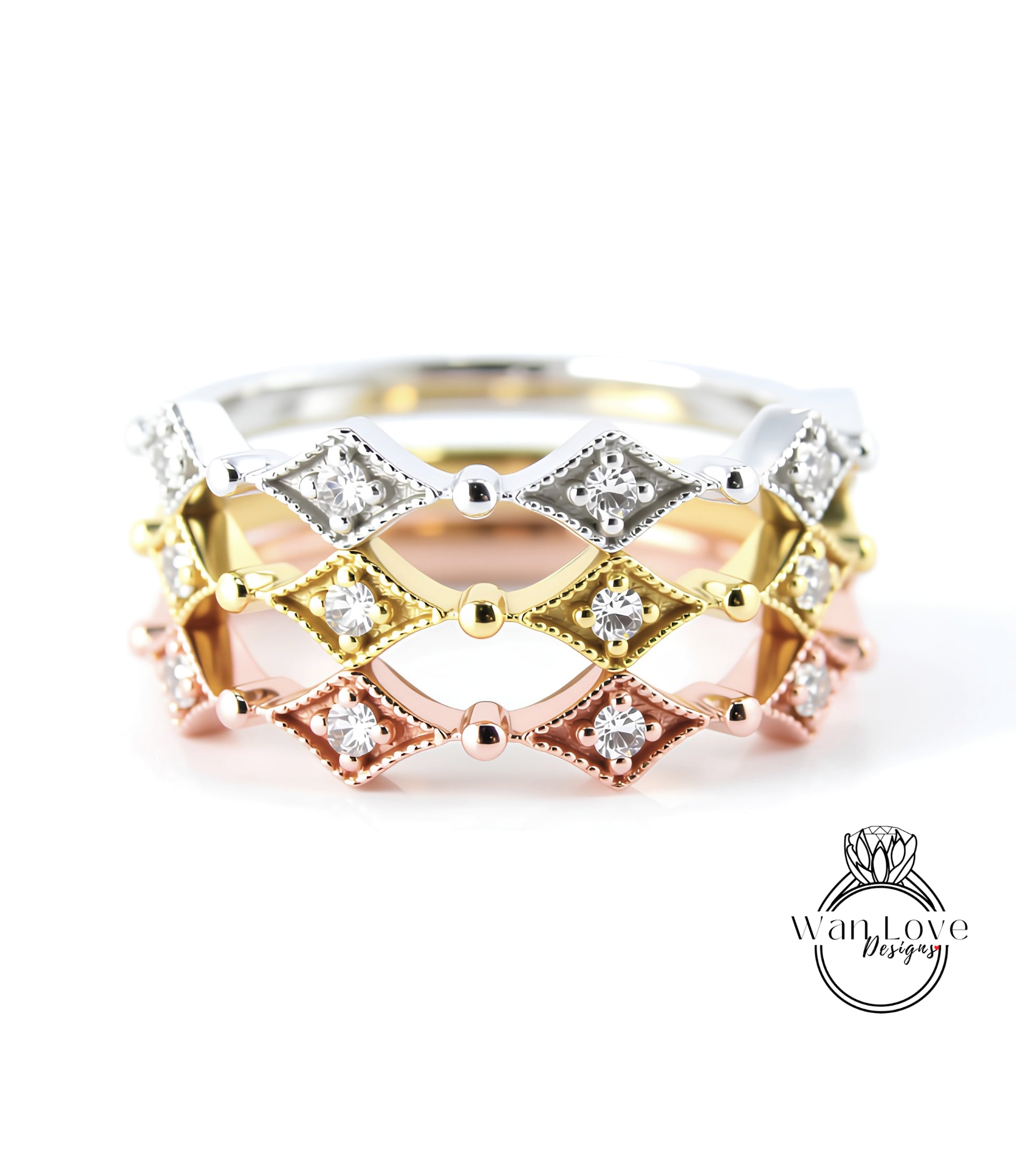 A close-up image of a ring with a diamond-encrusted band in various colors, including silver, gold, and pink.