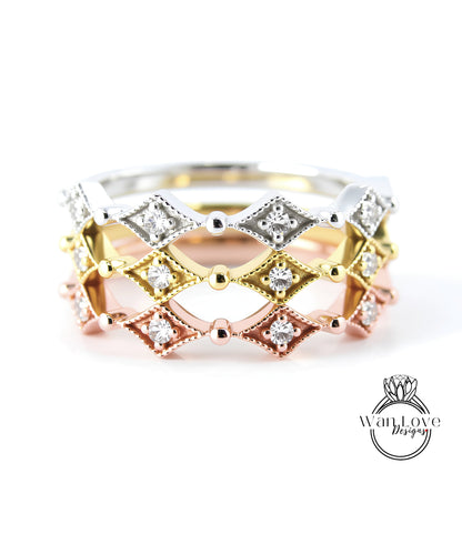 A close-up image of a ring with a diamond-encrusted band in various colors, including silver, gold, and pink.