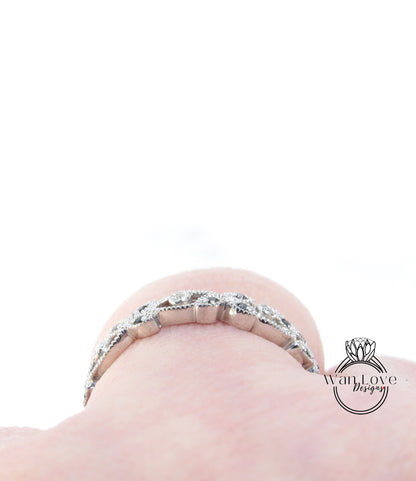 A close-up view of a delicate silver bracelet adorned with small diamonds, resting on a person's wrist.