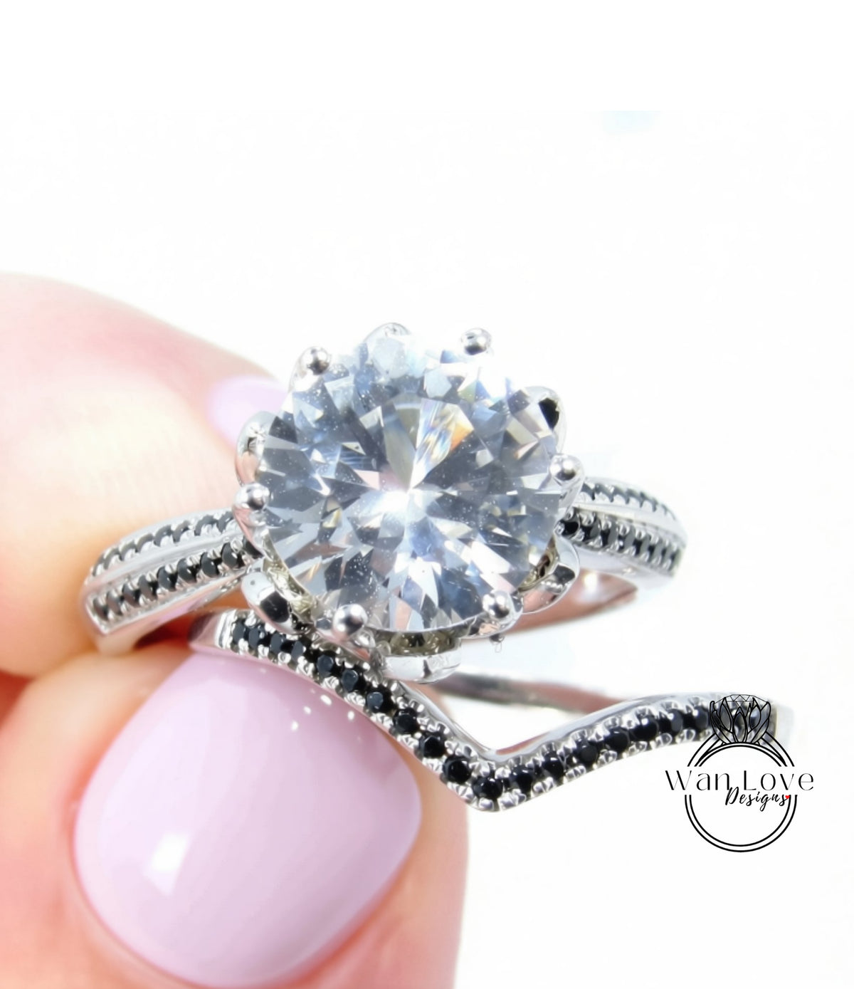 A close-up image of a person's hand holding a silver ring with a large, clear gemstone set in it.