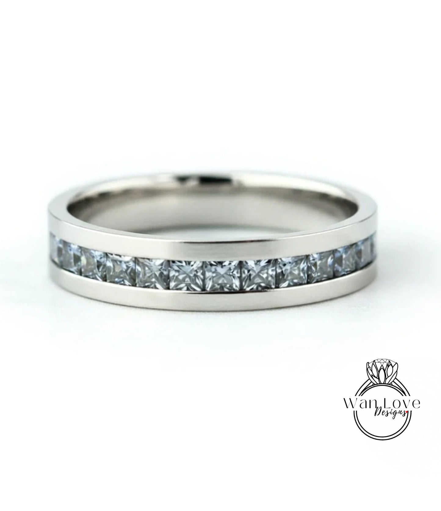 A silver band ring with a row of small diamonds set in it.