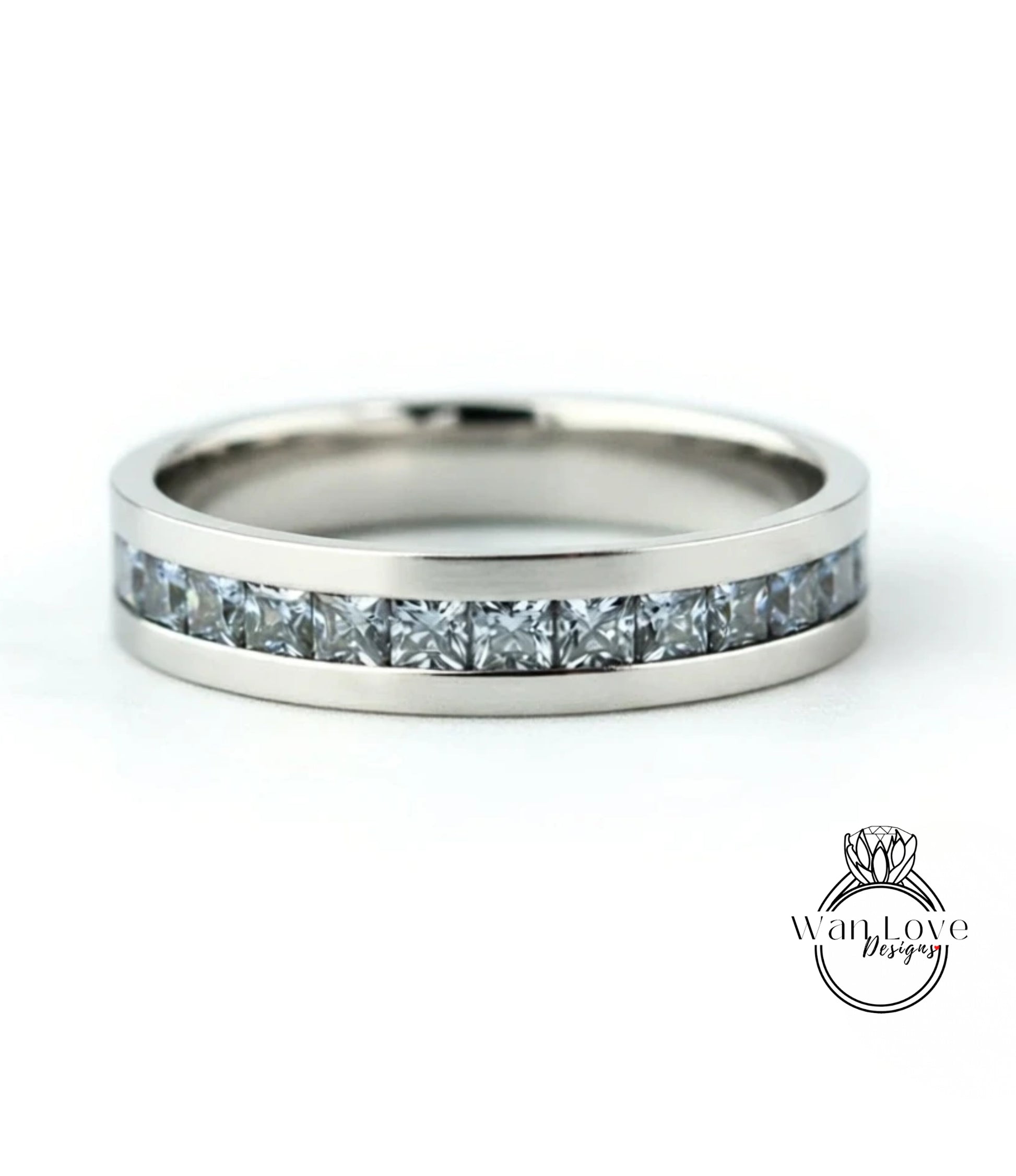 A silver band ring with a row of small diamonds set in it.