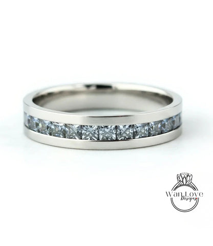A silver band ring with a row of small diamonds set in it.