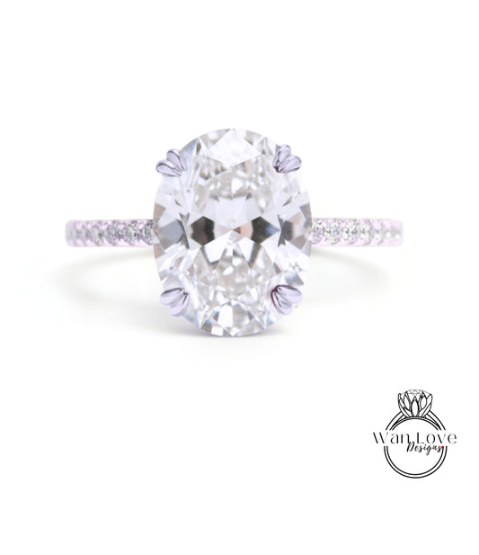 A large oval-shaped diamond engagement ring with a band of smaller diamonds.